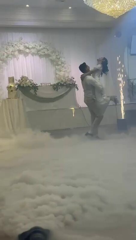 A first dance surrounded by low-lying clouds